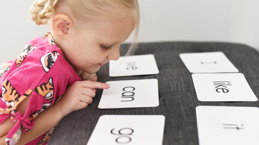 girl looking at sight word flashcards